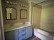 Bathroom featuring a dual-sink vanity and shower-tub combo at 710 Seals Rd, Dallas, GA 30157