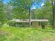 Single story home with covered porch and lush greenery on a sprawling lot at 710 Seals Rd, Dallas, GA 30157