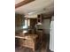 Kitchen with wood cabinets, breakfast bar, countertops, and appliances with island cooktop and wood laminate flooring at 710 Seals Rd, Dallas, GA 30157