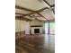 Bright living room features wood flooring, stone fireplace, ceiling fan, and sliding doors to an outdoor deck at 710 Seals Rd, Dallas, GA 30157