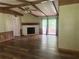 Spacious living room with wood floors, a vaulted ceiling, a fireplace, and sliding glass doors to the outside deck at 710 Seals Rd, Dallas, GA 30157
