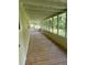 Enclosed, spacious screened porch with wood floors for relaxing at 710 Seals Rd, Dallas, GA 30157