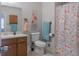 Bathroom with vanity, toilet, and shower with flamingo patterned shower curtain at 2650 Montego Dr, Buford, GA 30519