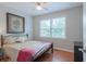 Cozy bedroom featuring wood floors, ceiling fan, and window with view of the outdoors at 2650 Montego Dr, Buford, GA 30519