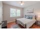 Inviting bedroom featuring wood floors, window with view of the outdoors, and ceiling fan at 2650 Montego Dr, Buford, GA 30519