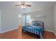 Bright bedroom with hardwood floors, a comfortable bed, and soothing wall decor at 2650 Montego Dr, Buford, GA 30519