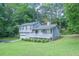Charming two-story home featuring a front porch, well-manicured lawn, and serene landscaping at 2650 Montego Dr, Buford, GA 30519