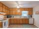 Functional kitchen featuring warm wood cabinets, essential appliances, and ample counter space at 2650 Montego Dr, Buford, GA 30519