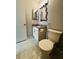Cozy half bath featuring tiled floors, granite counters, and a framed mirror at 3432 Ivys Walk, Atlanta, GA 30340