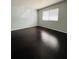 Bright bedroom with a large window and dark hardwood flooring at 3432 Ivys Walk, Atlanta, GA 30340