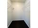 Small walk-in closet with black floors and white shelving at 3432 Ivys Walk, Atlanta, GA 30340