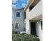 Inviting condo exterior featuring tidy landscaping, a private covered deck, and ample light at 3432 Ivys Walk, Atlanta, GA 30340