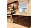 Modern kitchen with granite countertops, stainless steel oven, and dark wood cabinets at 3432 Ivys Walk, Atlanta, GA 30340