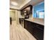 Modern kitchen showcasing dark wood cabinetry, granite countertops, stainless steel appliances and new tile floors at 3432 Ivys Walk, Atlanta, GA 30340