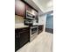 Stylish kitchen featuring stainless steel appliances, granite countertops, and dark wood cabinets at 3432 Ivys Walk, Atlanta, GA 30340