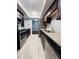 Modern kitchen with stainless steel appliances, granite countertops, dark cabinets and new wood tile floors at 3432 Ivys Walk, Atlanta, GA 30340