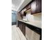 Modern kitchen with stainless steel appliances, granite countertops, dark cabinets and new tile floors at 3432 Ivys Walk, Atlanta, GA 30340