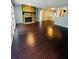 Spacious living room showcasing dark hardwood floors and a striking stone fireplace at 3432 Ivys Walk, Atlanta, GA 30340