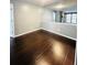 Bright living room featuring hardwood floors and mirrored wall adding depth to the space at 3432 Ivys Walk, Atlanta, GA 30340
