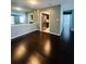 Open-concept living area with hardwood floors and a glimpse of a modern kitchen with stainless steel appliances at 3432 Ivys Walk, Atlanta, GA 30340