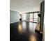 Cozy living room with hardwood floors, a stone fireplace, and sliding barn doors leading to a bright space at 3432 Ivys Walk, Atlanta, GA 30340