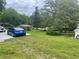 The home features a large, grassy backyard with a beautiful mature tree, perfect for outdoor activities at 3629 Centerview Dr, Marietta, GA 30066