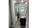 Bathroom featuring tiled shower, window, and vanity with dark wood at 3629 Centerview Dr, Marietta, GA 30066