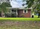 Charming brick house featuring a covered front porch and well-maintained landscaping in quiet neighborhood at 3629 Centerview Dr, Marietta, GA 30066