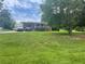 A well-maintained front yard with lush green grass complements this charming home with mature trees in background at 3629 Centerview Dr, Marietta, GA 30066