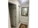 Hallway view featuring doors, tiled floors, and a decorative wall mirror at 3629 Centerview Dr, Marietta, GA 30066