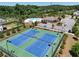 Aerial view featuring tennis courts, a pool, clubhouse, landscaping, and surrounding neighborhood at 4255 Sunflower Cir, Cumming, GA 30040