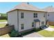 Light gray two story home featuring a small patio and deck at 4255 Sunflower Cir, Cumming, GA 30040