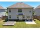 Light gray two-story home with a covered patio and well-kept yard at 4255 Sunflower Cir, Cumming, GA 30040