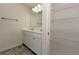 Bright bathroom featuring a double sink vanity and linen closet at 4255 Sunflower Cir, Cumming, GA 30040