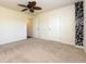 Cozy bedroom with a ceiling fan and neutral carpet flooring at 4255 Sunflower Cir, Cumming, GA 30040