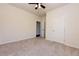 Neutral carpeted bedroom includes a ceiling fan, closet, and a door to the hallway at 4255 Sunflower Cir, Cumming, GA 30040