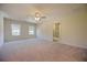 Large bedroom with plush carpet, dual windows, and an ensuite bathroom at 4255 Sunflower Cir, Cumming, GA 30040