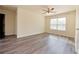 Spacious bedroom featuring hardwood floors, a ceiling fan and a bright window at 4255 Sunflower Cir, Cumming, GA 30040