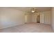 Spacious bedroom with neutral carpet and two entryways, featuring overhead ceiling fan at 4255 Sunflower Cir, Cumming, GA 30040
