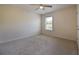 This cozy bedroom has neutral colored walls, soft carpet, and a light-filled window at 4255 Sunflower Cir, Cumming, GA 30040