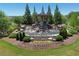 Bramblett Grove entrance featuring a waterfall and landscaping at 4255 Sunflower Cir, Cumming, GA 30040