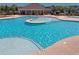 Community pool and clubhouse with chairs and umbrellas at 4255 Sunflower Cir, Cumming, GA 30040
