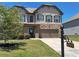 Traditional two-story home featuring manicured lawn and a covered porch at 4255 Sunflower Cir, Cumming, GA 30040