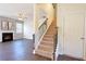 Cozy living room featuring a fireplace, staircase, and sleek wood floors at 4255 Sunflower Cir, Cumming, GA 30040