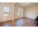 Bright, spacious living room with a large window providing natural light and attractive wood flooring at 4255 Sunflower Cir, Cumming, GA 30040