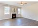 Bright living room with a fireplace and gray wood floors that create a cozy and stylish atmosphere at 4255 Sunflower Cir, Cumming, GA 30040