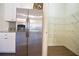 Conveniently located stainless steel refrigerator with walk-in pantry with organized shelving at 4255 Sunflower Cir, Cumming, GA 30040
