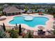 Aerial view of community pool with distinct areas for different ages and a pool house surrounded by sun loungers at 4255 Sunflower Cir, Cumming, GA 30040