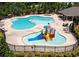 Community pool with different areas for swimming and a splash area with a slide and mushroom water feature at 4255 Sunflower Cir, Cumming, GA 30040