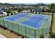 Two well-maintained tennis courts with new nets, surrounded by green landscaping and a secure fence at 4255 Sunflower Cir, Cumming, GA 30040